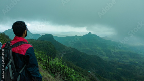 A person looking at a mountain peak © AkhileshSarfare