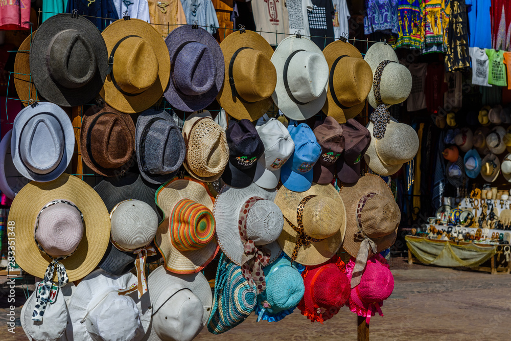 Different hats for sale in a street shop