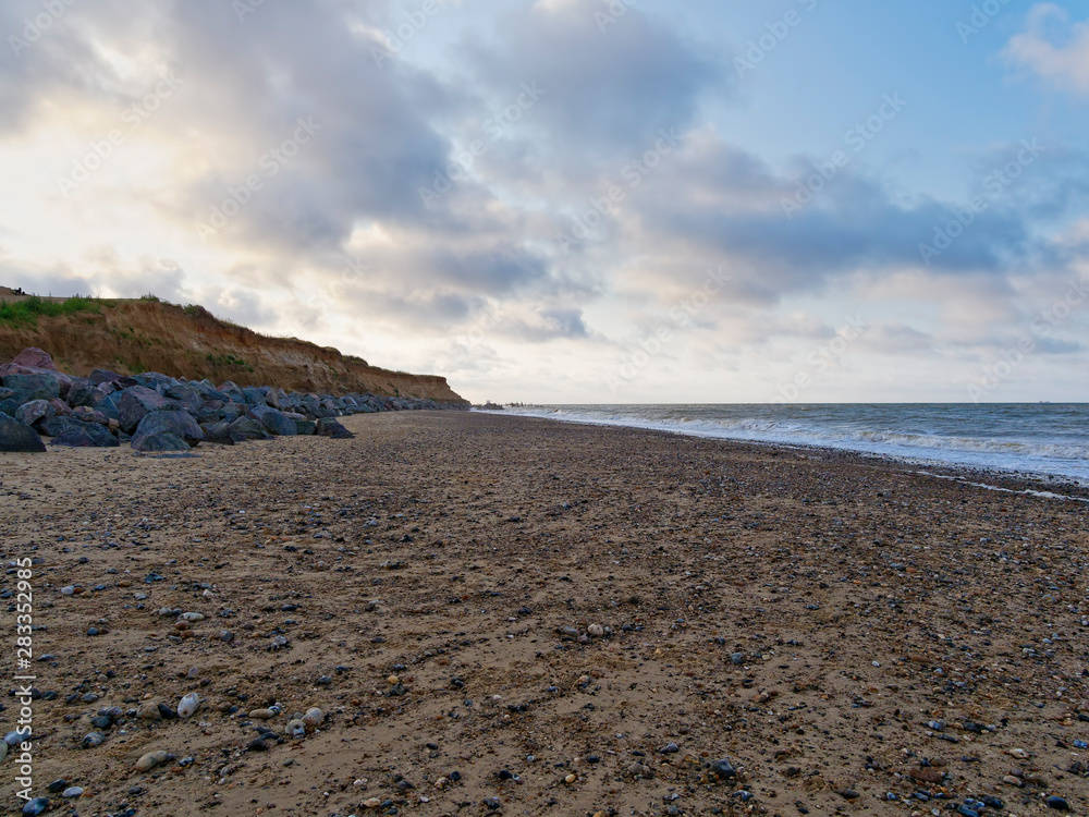 Large rocks help protect the fragile cliffs of Happisburgh beach from coastal erosion