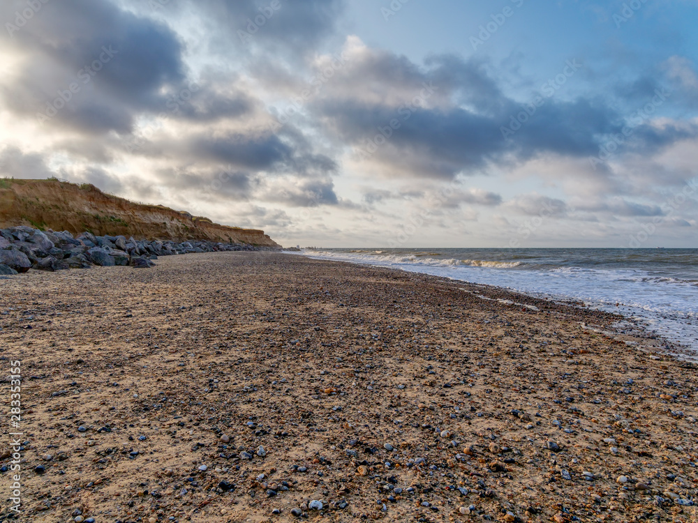 Dark clouds roll in from the North Sea, passing over Happisburgh beach in Norfolk, East Anglia.