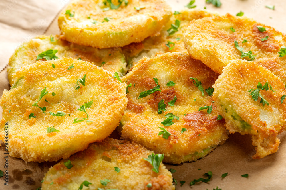 Fried slices of zucchini with green chopped parsley