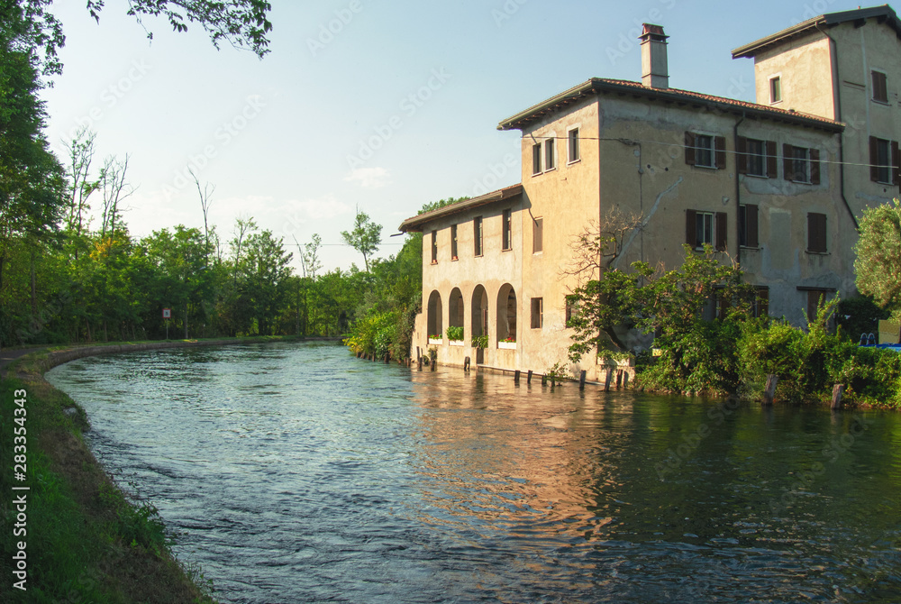 farmhouse overlooking the canal in the park of the Ticino river near Milan, Italy