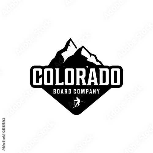 illustration silhouette of a high Colorado mountain with a man skiing logo design