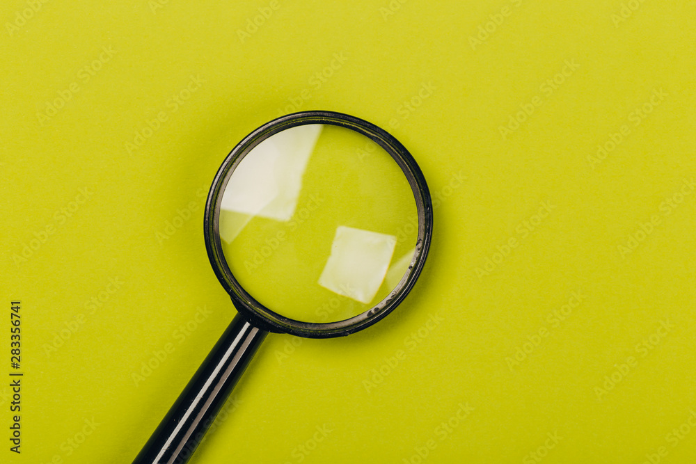 Small magnifying glass on green background Small magnifying glass on green background