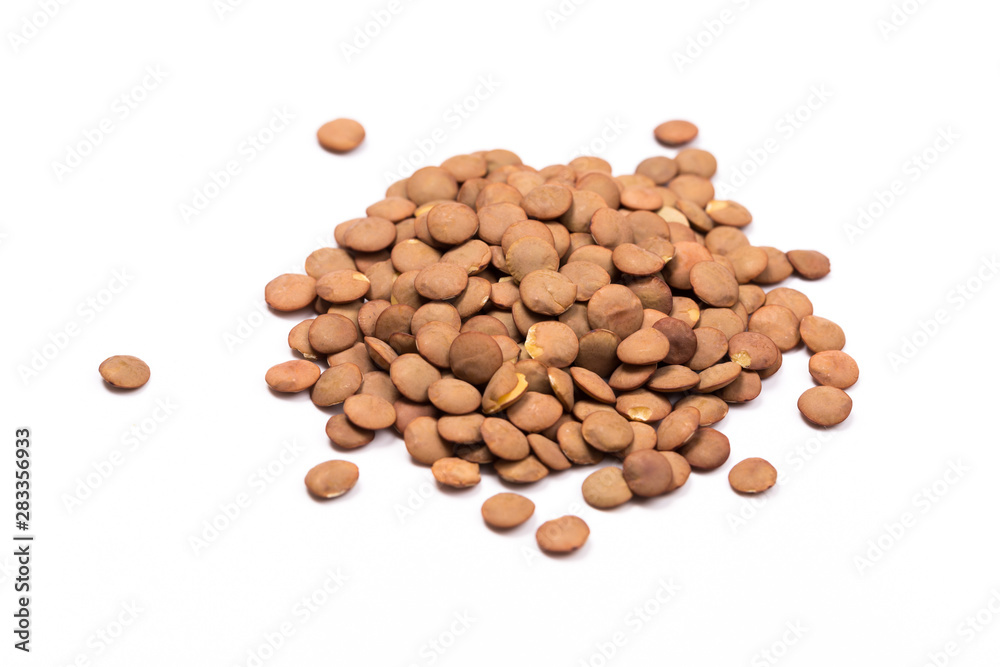 Isolated stack of uncooked lentils on white background from above. Isolated stack of uncooked lentils on white background from above.