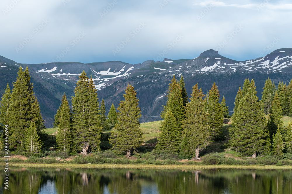 San Juan Mountains landscape of meadow, trees and snow-capped mountains in Colorado