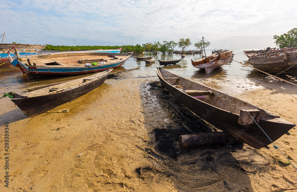 dhow wooden hulls moored awaiting repairs and refurbishment at a traditional zanzibar beach harbor dhow wooden hulls moored awaiting repairs and refurbishment at a traditional zanzibar beach harbor