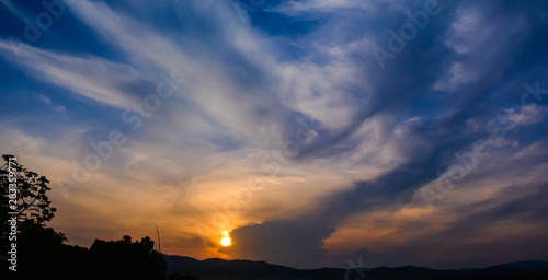 Morning sky with clouds with silhouette tree and mountain background