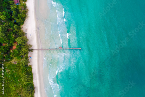 Tropical sea wave white sand beach with green tree aerial view in Koh Kood
