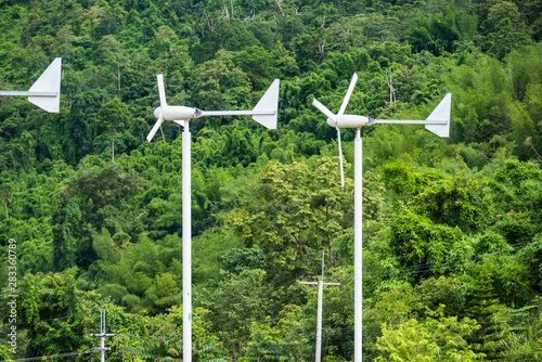 Wind turbine against clean energy, create energy in the forest.