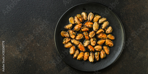 mussels in oil (delicious seafood) portion serving. top food background. copy space
