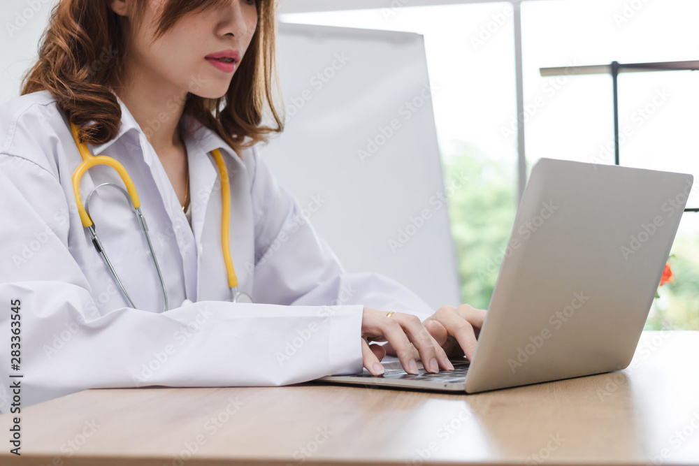 Medicine young Asian female doctor with laptop working in hospital office. Health care and medical concept. Medicine young Asian female doctor with laptop working in hospital office. Health care and medical concept.