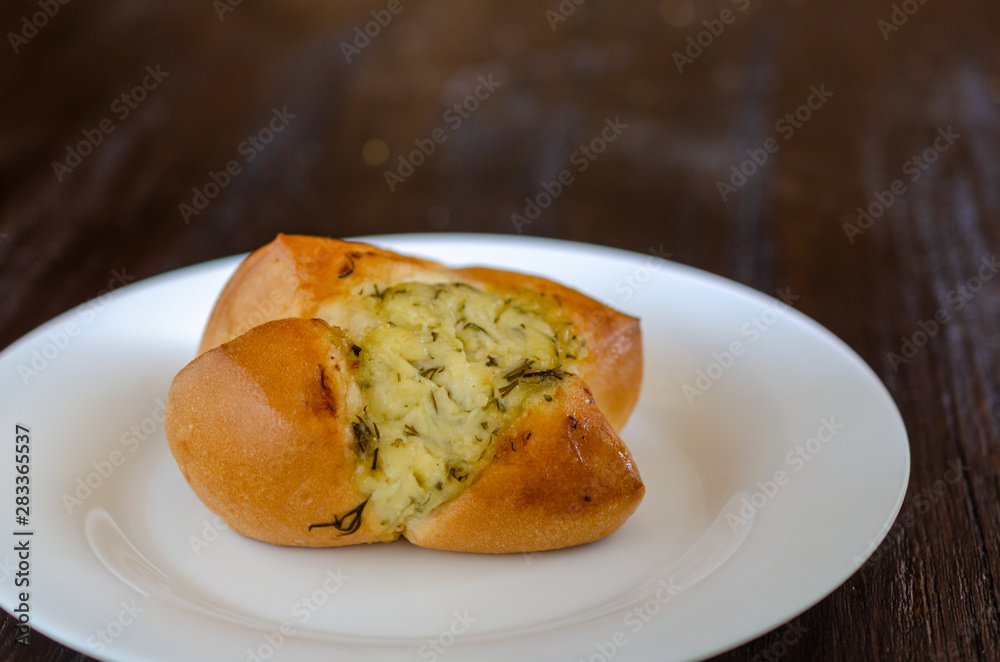 Homemade buns in white plate on wooden background Homemade buns in white plate on wooden background