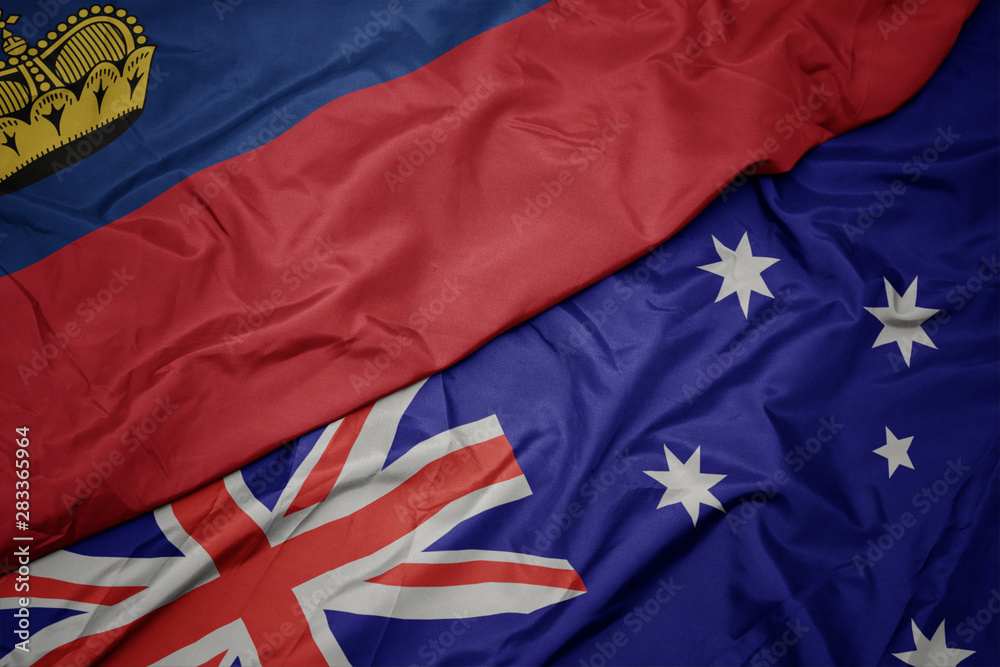 waving colorful flag of australia and national flag of liechtenstein. waving colorful flag of australia and national flag of liechtenstein.