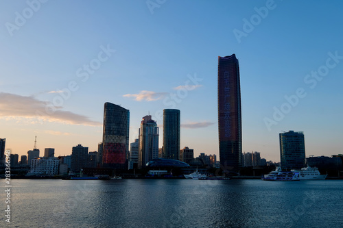 sunrise of the North Bund in Shanghai. New area of commercial and trade center. Skyscraper on the bank of Huangpu River. Transtalation of words on building is Magnolia Plaza welcome you