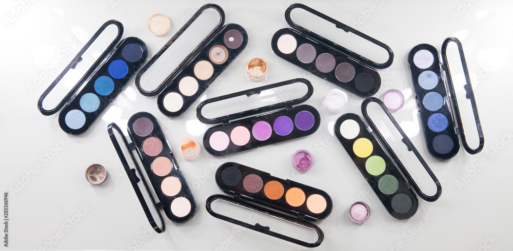 Different color eye shadows palette isolated on white background. Panoramic banner with free space for text mockup Different color eye shadows palette isolated on white background. Panoramic banner with free space for text mockup