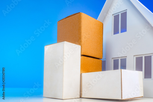 Parcels are at the house. Postage to the door. Parcel delivery company. Delivery of goods concept. Delivery of the order from the online store. Pile of stacked cardboard boxes with furniture.