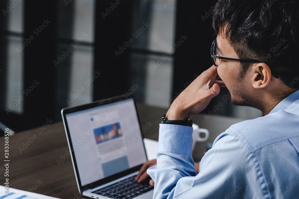 asian businessman woking with laptop and paper work on desk at office.digital workflow online business lifestyle concept. asian businessman woking with laptop and paper work on desk at office.digital workflow online business lifestyle concept.