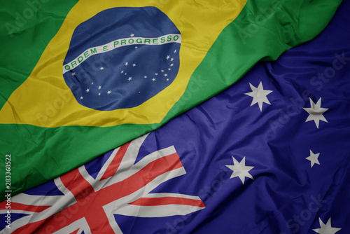 waving colorful flag of australia and national flag of brazil.