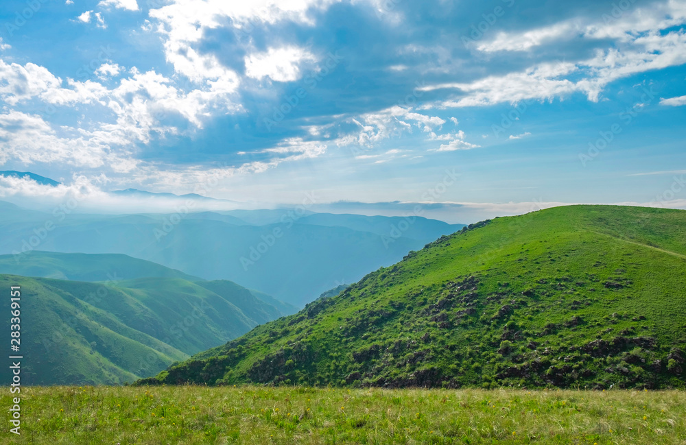 Amazing summer landscape, view to the green hills and beautiful sky