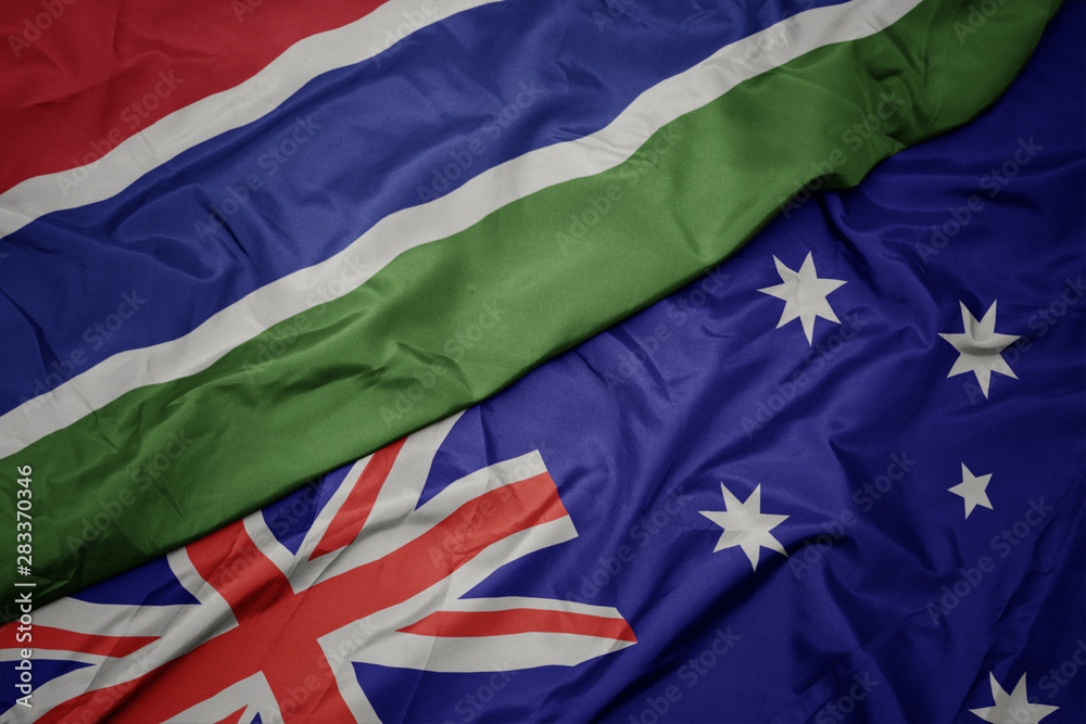 waving colorful flag of australia and national flag of gambia