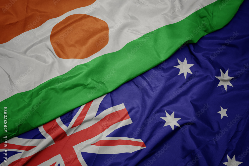 waving colorful flag of australia and national flag of niger. waving colorful flag of australia and national flag of niger.