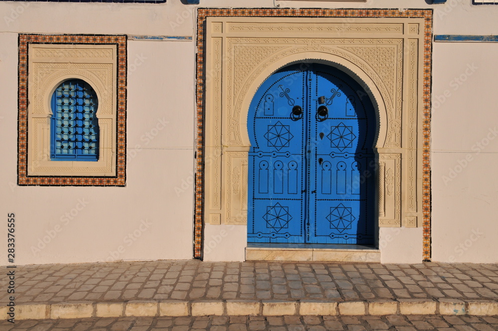 Medina Kairouan, typical blue door, beautiful islamic ornaments, horseshoe-arch