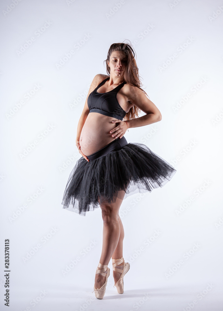 Naklejka premium Young beautiful pregnant ballerina with black dress.