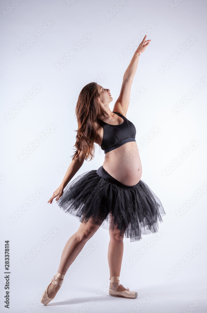 Young beautiful pregnant ballerina with black dress. Young beautiful pregnant ballerina with black dress.