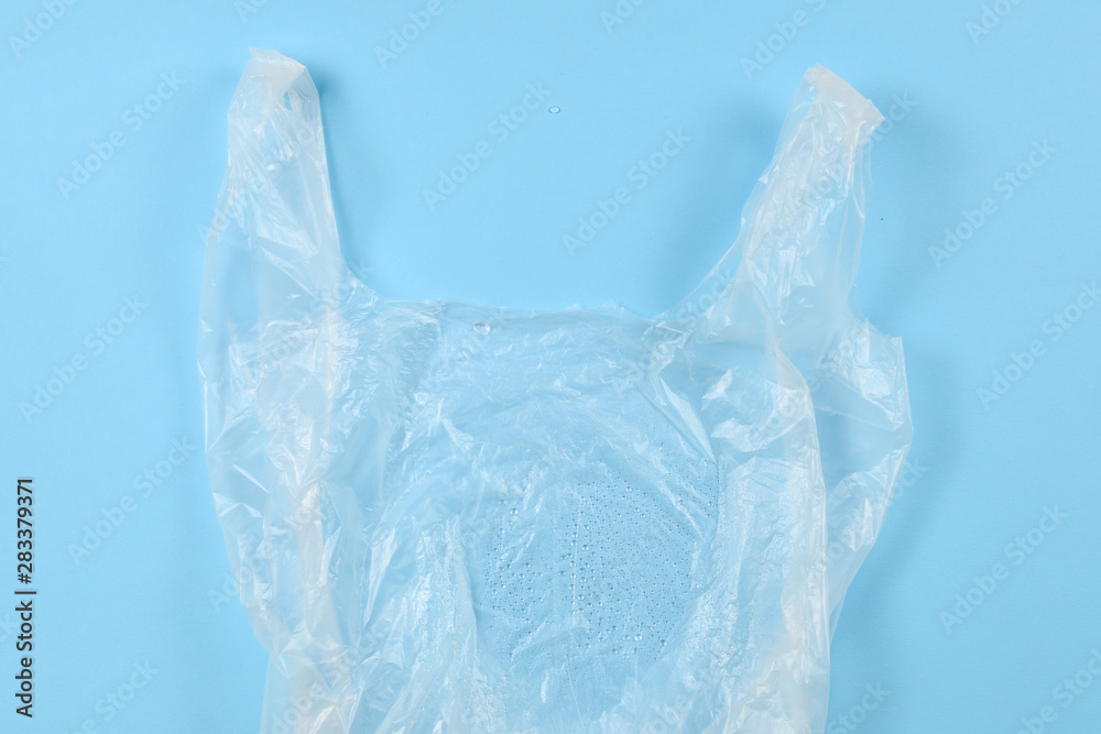 Cellophane bag on a blue background. Top view. Cellophane bag on a blue background. Top view.