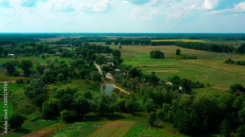 4K Drone. Aerial view of Desna, an urban-type settlement in Kozelets Raion, Chernihiv Oblast in northern Ukraine. Shot on a bright summer day with blue sky and few clouds. photo