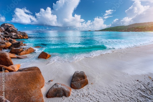 Fototapeta Naklejka Na Ścianę i Meble -  Impressive clouds above crystal clear ocean and beautiful tropical beach. Seychelles Grand Anse, La Digue, Seychelles
