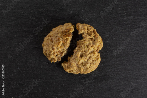 Group of two halves of oat crumble biscuit flatlay on grey stone