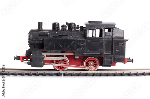 Steam train model on rails on a white background
