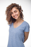 Portrait of a smiling Indian girl on a white isolated background. Beautiful young mixed race woman with a shaggy hairstyle. 