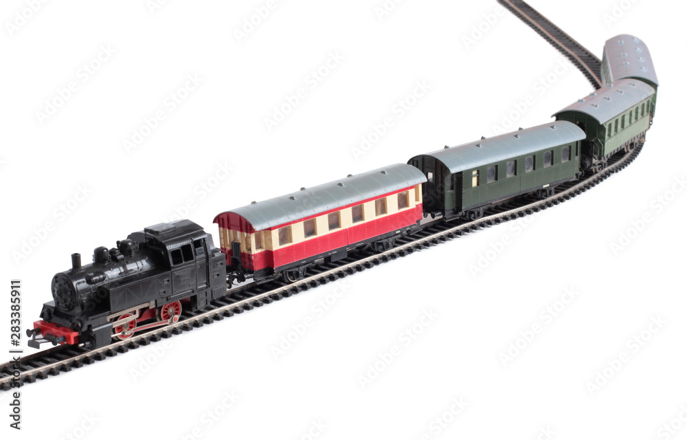 Obraz premium Model of a steam locomotive and passenger cars on rails on a white background