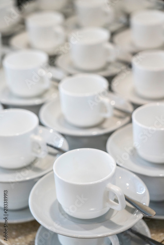 Serving white porcelain coffee and tea cups with saucer