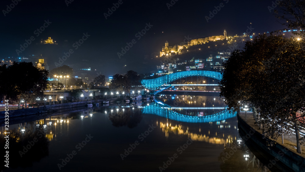 Pedestrian bridge of peace over the Mtkvari (Kura) River in Tbilisi at night. Narikala fortress. Pedestrian bridge of peace over the Mtkvari (Kura) River in Tbilisi at night. Narikala fortress.