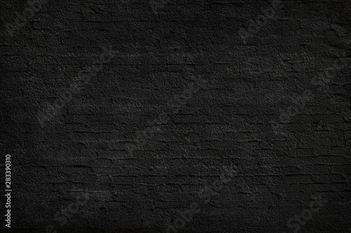 Texture of black, plastered brick wall.