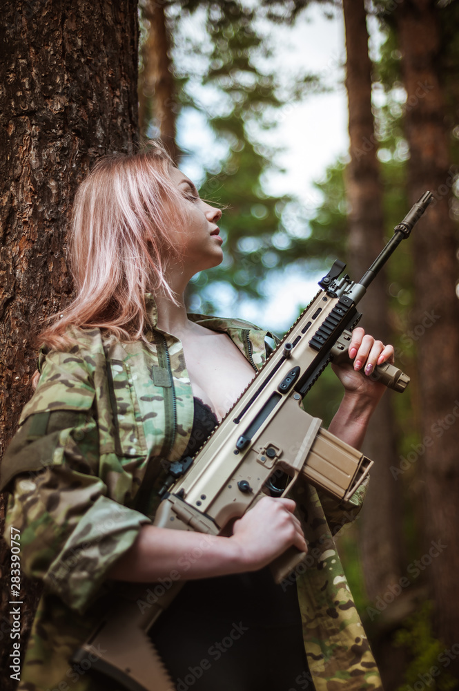 Beautiful portrait of a girl holding a gun
