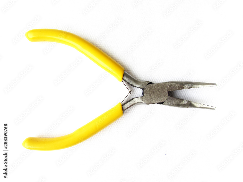 Small crooked pliers with bright yellow handles for a hobby isolated object on a white background. Small crooked pliers with bright yellow handles for a hobby isolated object on a white background.