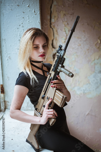 Wallpaper Mural Beautiful portrait of a girl holding a gun Torontodigital.ca