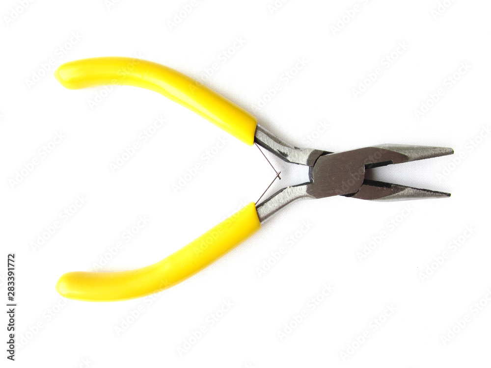 Small thin-nose pliers with bright yellow handles for a hobby isolated object on a white background. Small thin-nose pliers with bright yellow handles for a hobby isolated object on a white background.