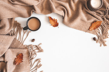 Autumn composition. Cup of coffee, plaid, autumn leaves on white background. Flat lay, top view, copy space