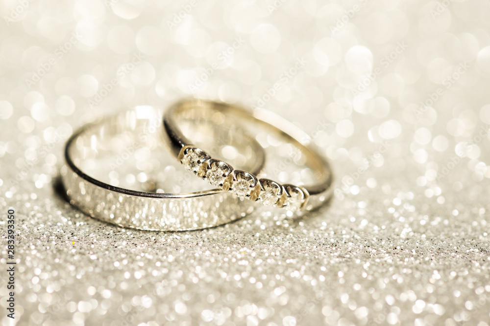 Gold wedding rings. Glitter background Gold wedding rings. Glitter background