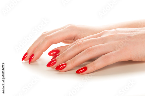 Woman showing manicured hands with red nail polish