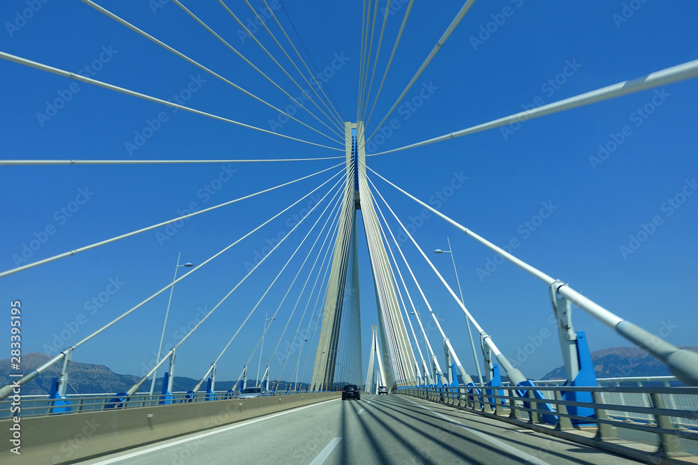 Driving through famous modern anti seismic cable bridge of Rio Antirio Harilaos Trikoupis that connects Peloponnese to mainland Greece Driving through famous modern anti seismic cable bridge of Rio Antirio Harilaos Trikoupis that connects Peloponnese to mainland Greece