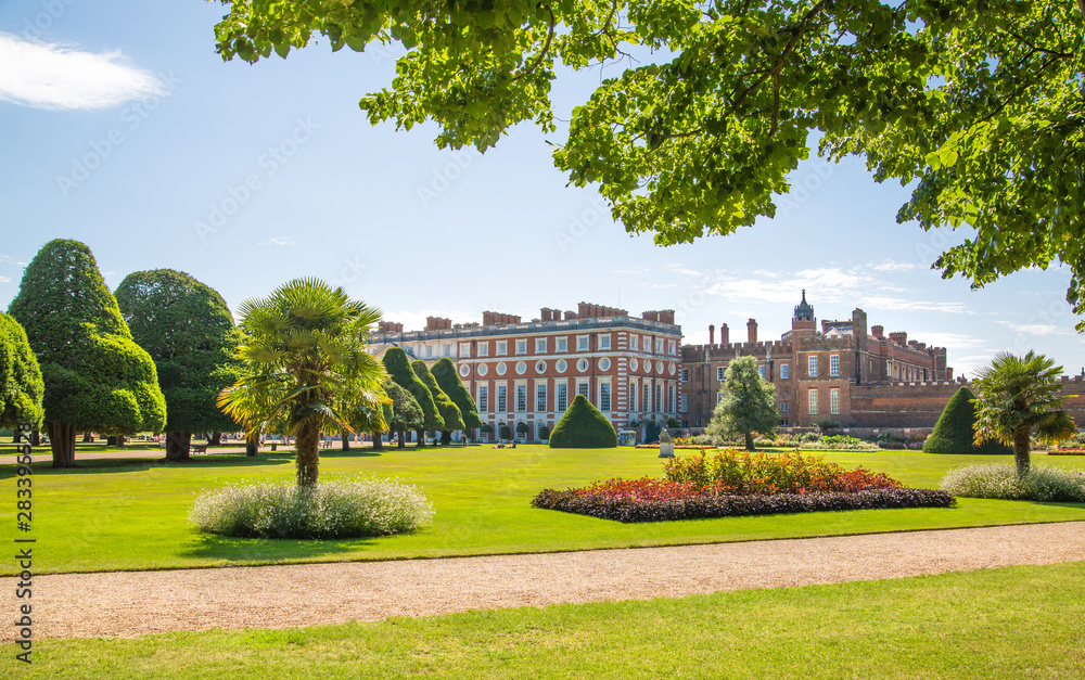 London, UK. English garden view and the East Front of Hampton court 17th century locates West London