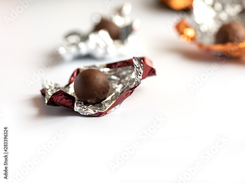 hocolate praline wrapped in foil. Isolated on white background photo