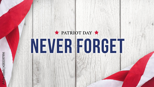 Never Forget - Patriot Day Text Over White Wood with Flags